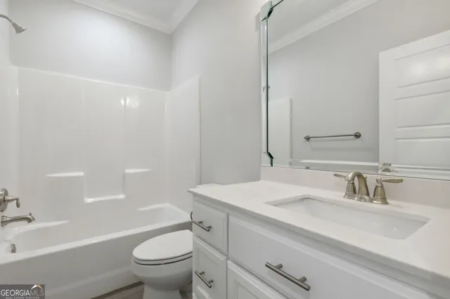a bathroom with a sink a toilet and a large mirror