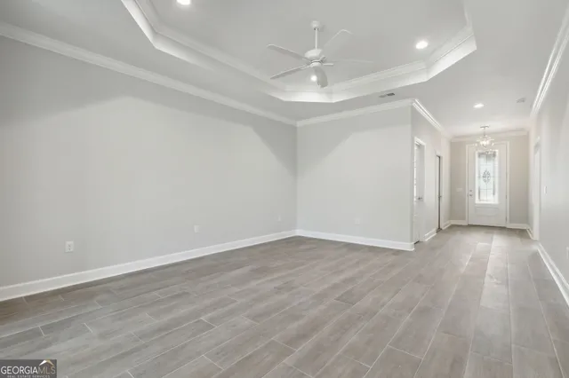 a view of an empty room with wooden floor