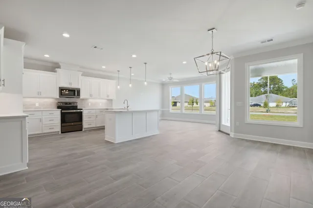 a view of a kitchen with a sink and microwave