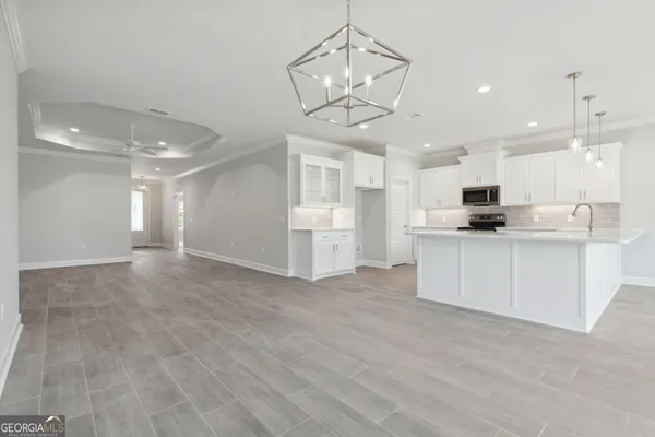 a view of a kitchen with a sink stainless steel appliances and cabinets