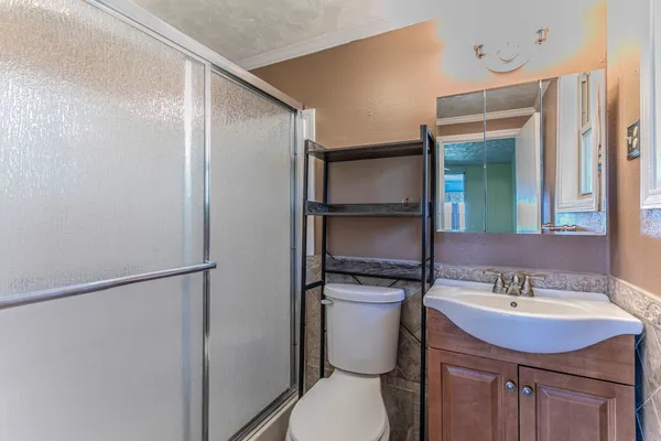 a bathroom with a sink toilet and shower