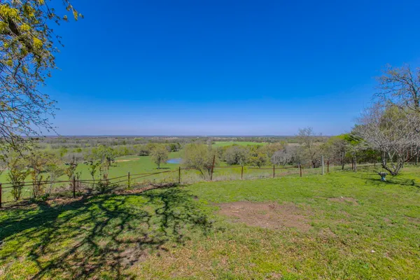 a view of a field with an ocean