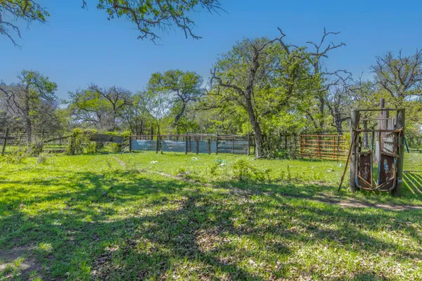 a view of yard with swimming pool and green space
