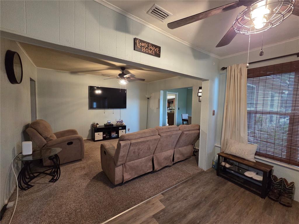 124 East F Street Frostproof, FL 33843 - Photo 2 of 37 a living room with furniture and a flat screen tv