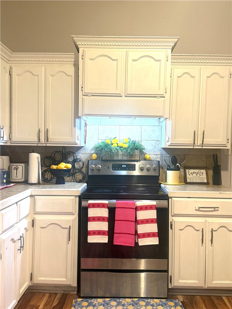 420 East 4th Street Alice, TX 78332 - Photo 16 of 28 a kitchen with stainless steel appliances granite countertop a stove and cabinets