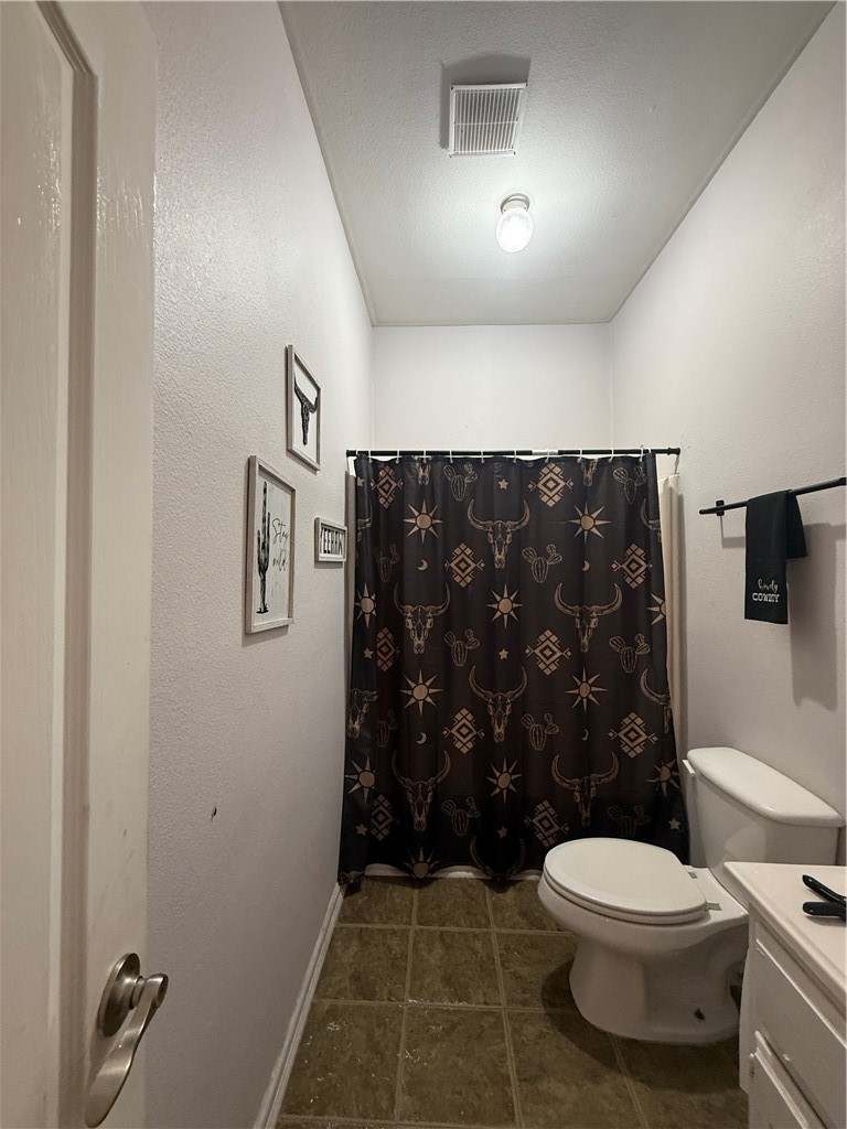 420 East 4th Street Alice, TX 78332 - Photo 22 of 28 a bathroom with a toilet and a shower