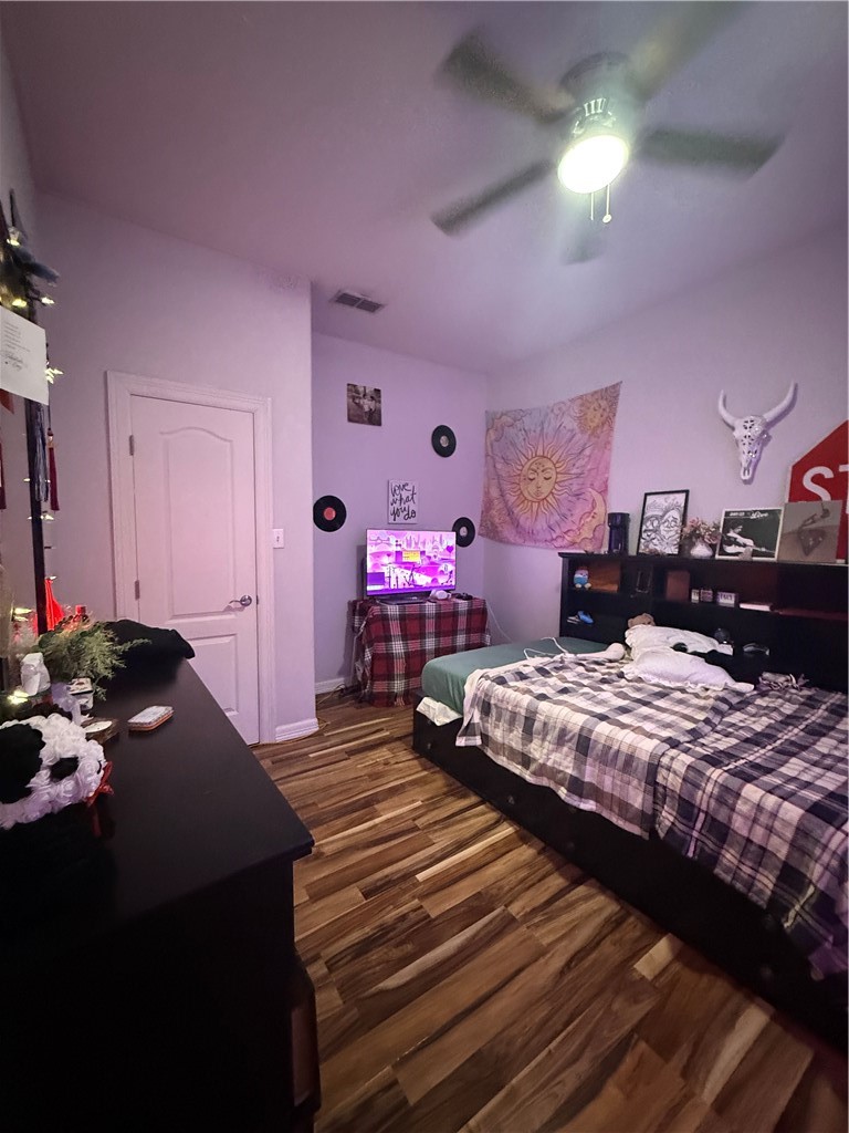 420 East 4th Street Alice, TX 78332 - Photo 23 of 28 a bedroom with bed and a chandelier