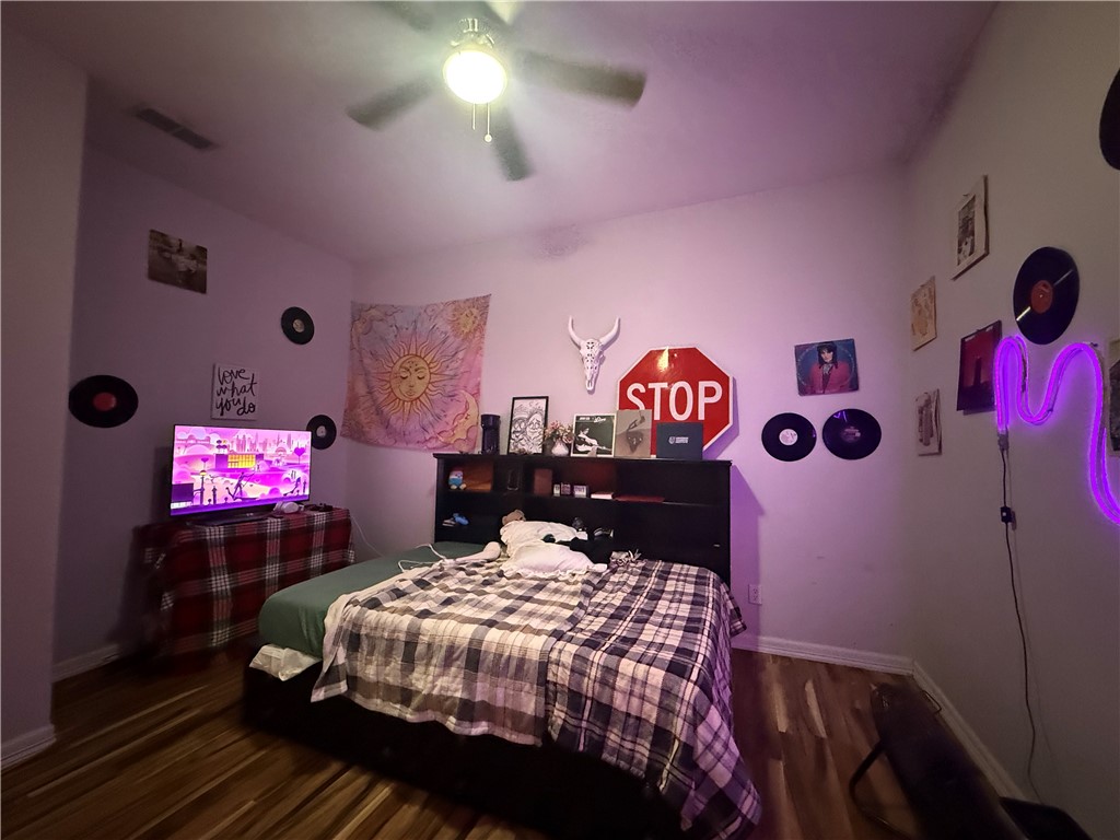 420 East 4th Street Alice, TX 78332 - Photo 24 of 28 a bedroom with a bed and a lamp on dresser