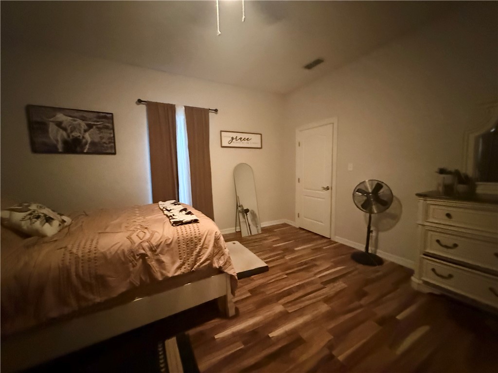 420 East 4th Street Alice, TX 78332 - Photo 26 of 28 a bedroom with a bed and a flat screen tv