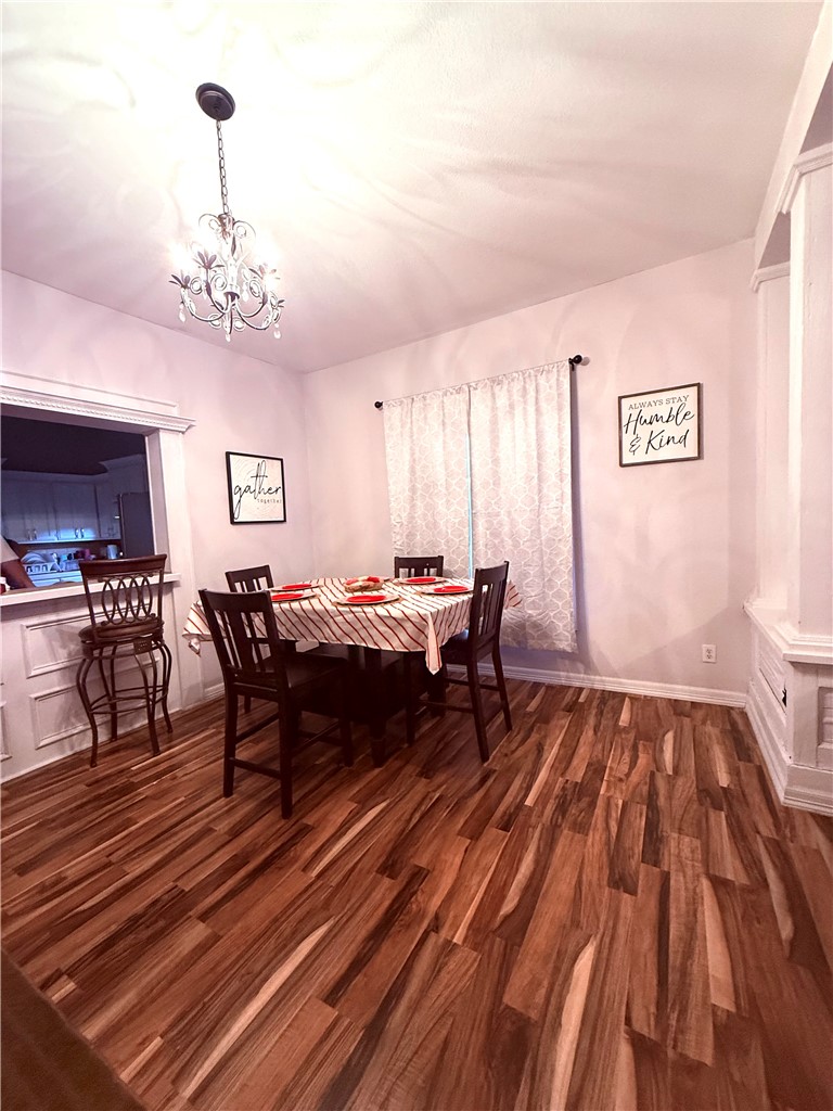 420 East 4th Street Alice, TX 78332 - Photo 8 of 28 a living room with furniture and a chandelier