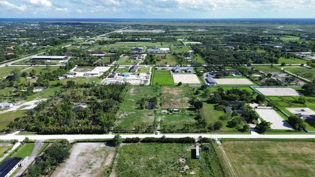 an aerial view of residential houses with outdoor space and swimming pool
