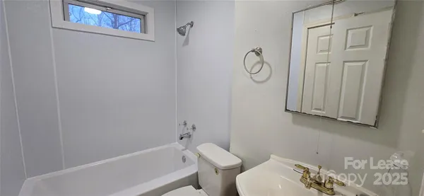 a bathroom with a toilet and a bathtub