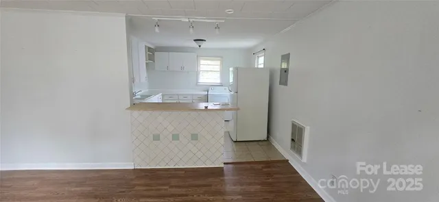 a view of a kitchen cabinets and wooden floor