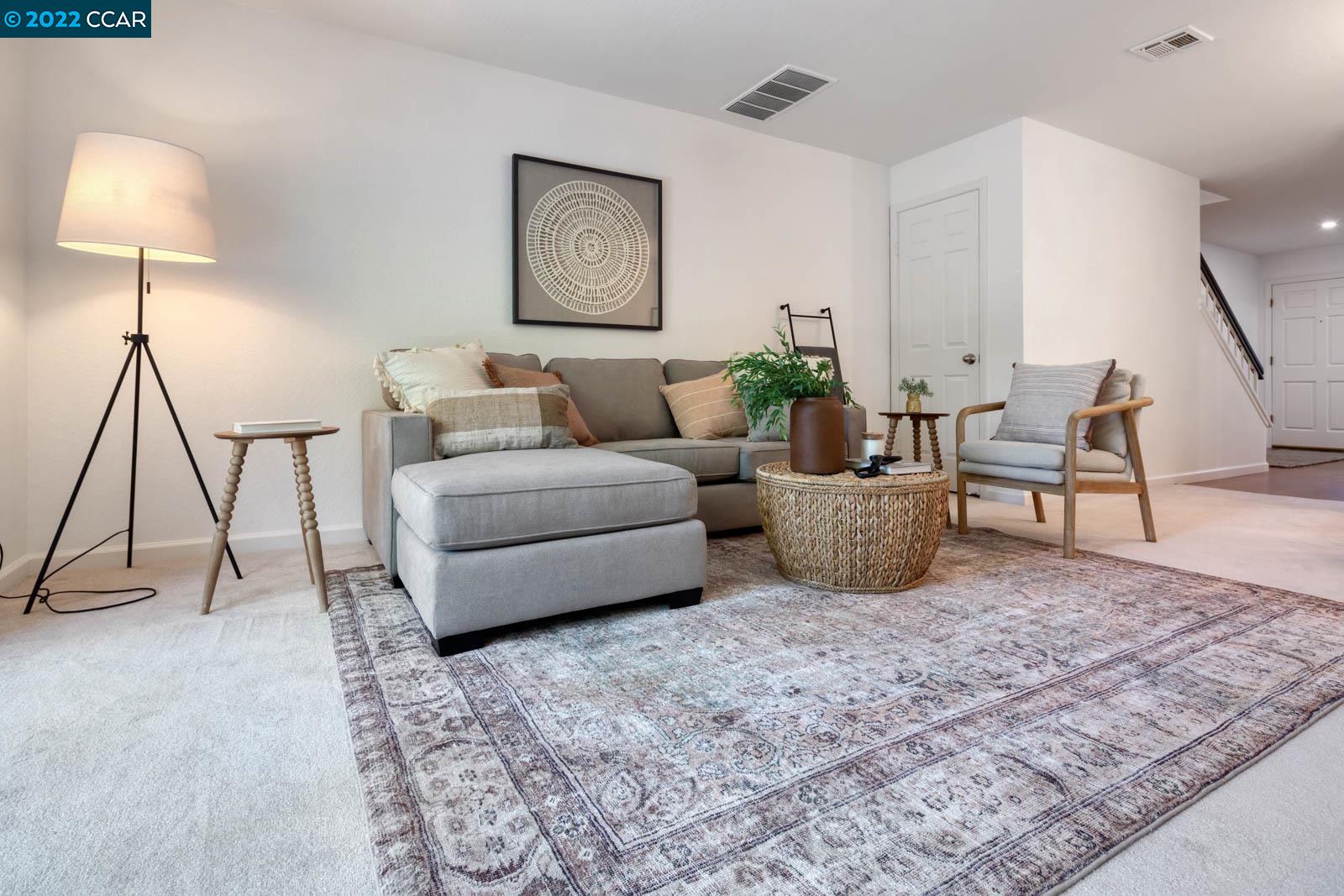 a living room with furniture and a rug