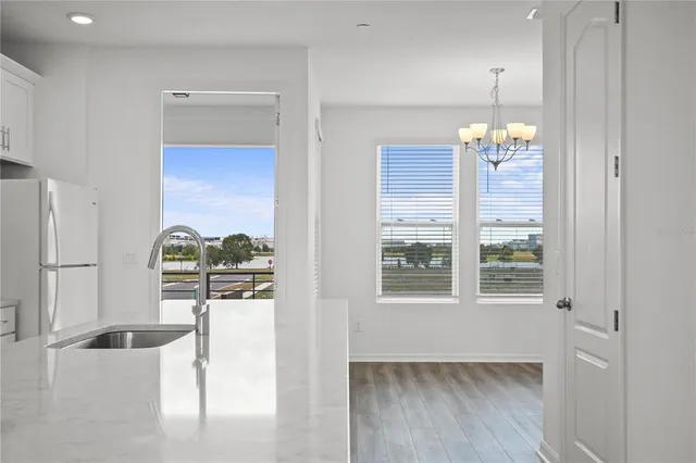 a view of a living room with hardwood floor and chandelier