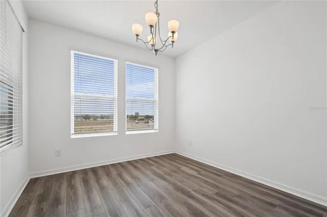 a view of a room with wooden floor and windows