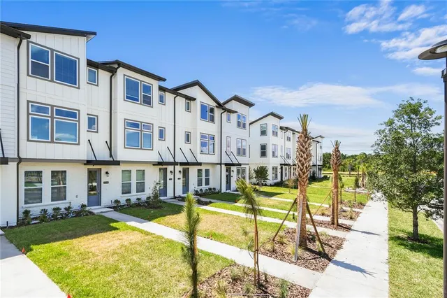 a garden with lots of trees in the background