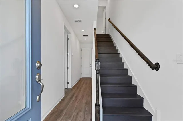 a view of entryway and gallery with wooden floor