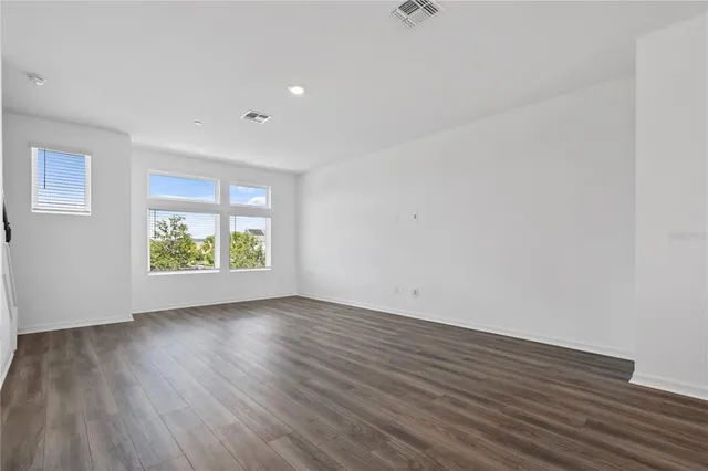 a view of room with window and wooden floor