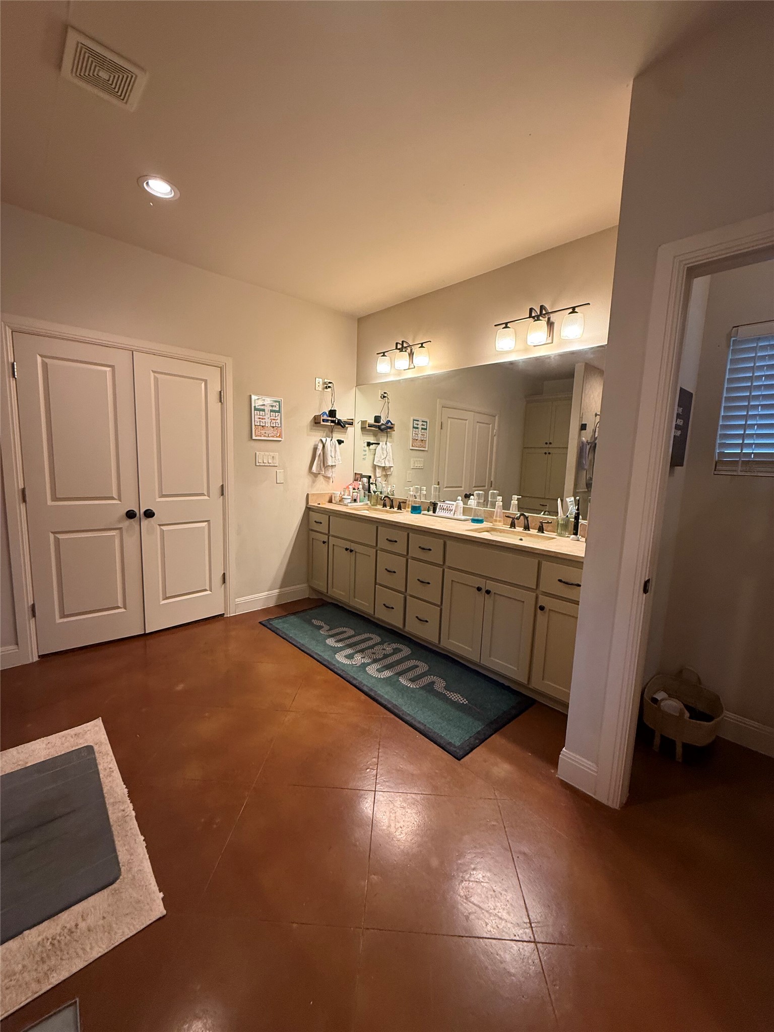 408 West Croslin Street Austin, TX 78752 - Photo 10 of 29 Double vanities and ample storage define this functional and well-appointed bathroom.