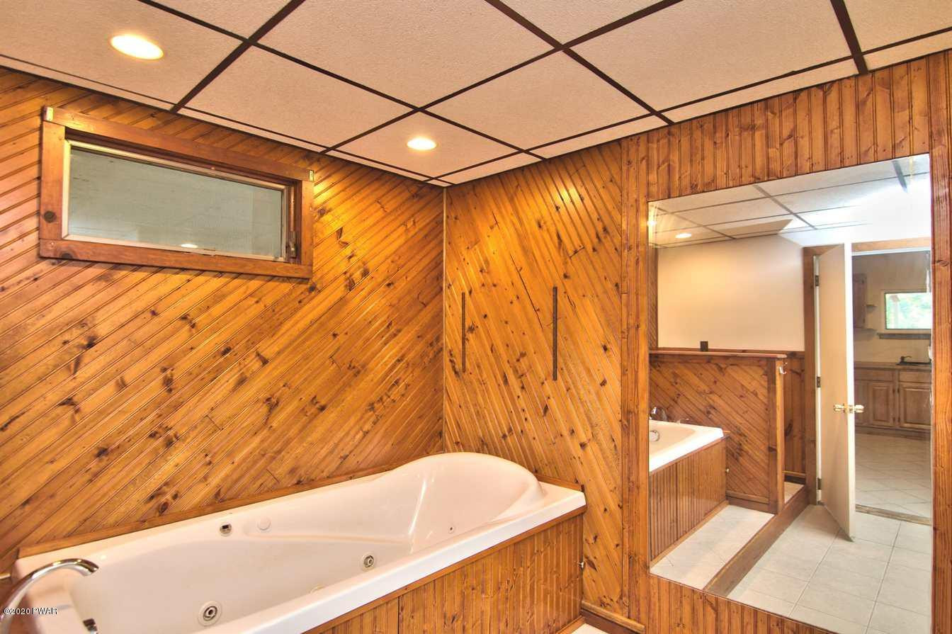 5690 Haas Pond Road Moscow, PA 18444 - Photo 25 of 79 a bathroom with a bathtub and a shower