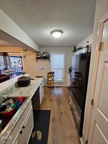 a kitchen with stainless steel appliances granite countertop a sink and a stove