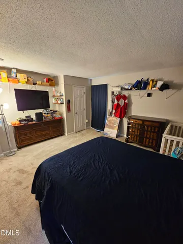 a bedroom with a bed and dresser