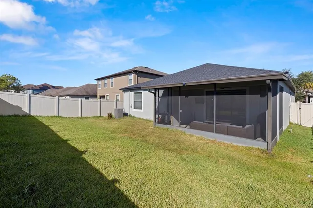 a view of a house with a backyard
