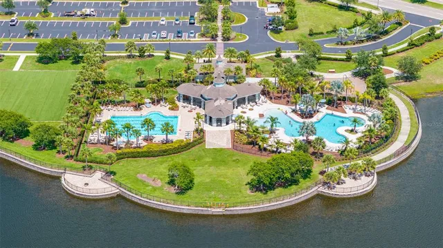 a view of a small pond with lots of green space