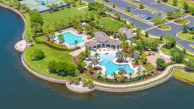 a view of a swimming pool with lawn chairs