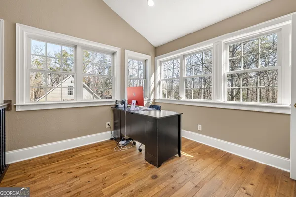 a spacious bedroom with a bed and a ceiling fan