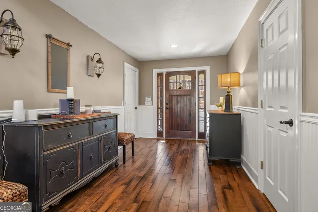 a living room with furniture large window and a fireplace