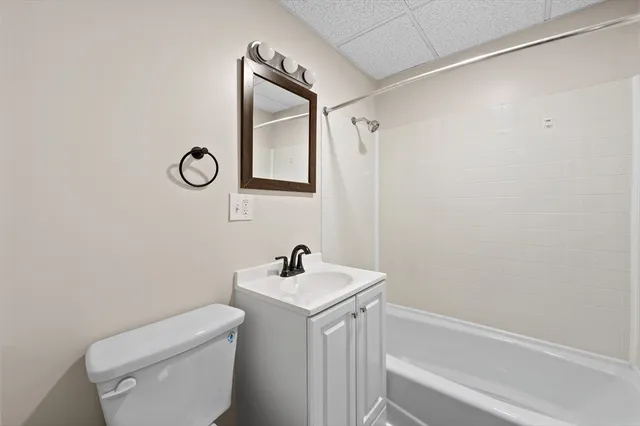 a bathroom with a toilet a sink and a mirror