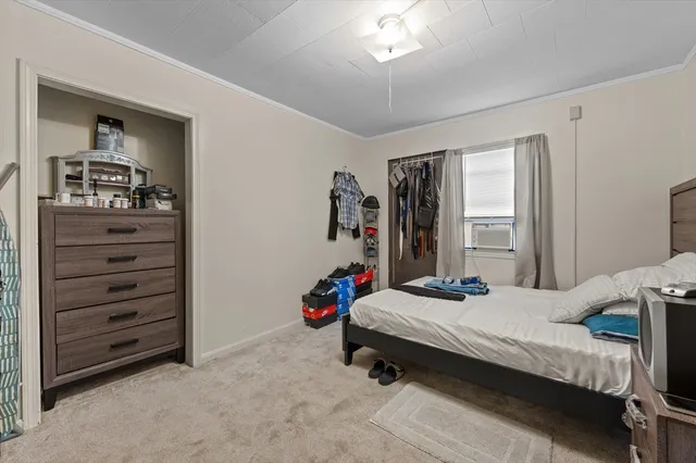 a bedroom with a bed and a chandelier