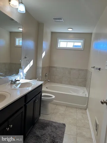 a bathroom with a sink a toilet and bathtub