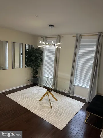 a view of a room with furniture and wooden floor