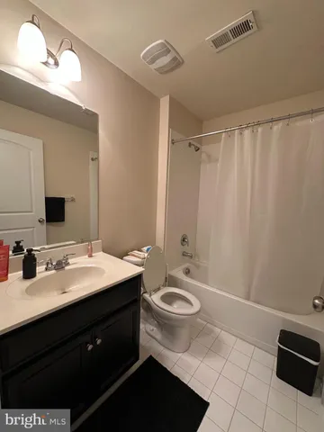 a bathroom with a double vanity sink toilet and mirror