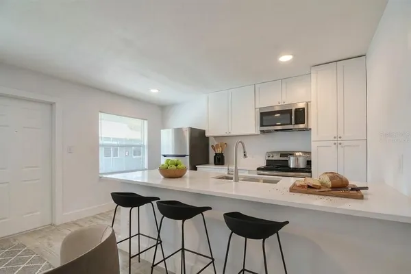 a kitchen with a sink cabinets and window