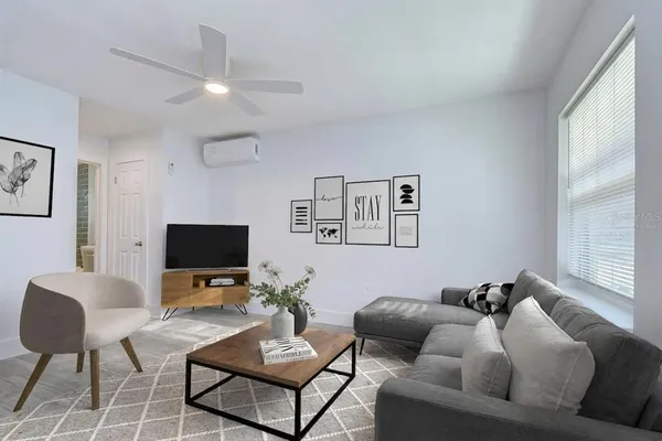 a living room with furniture and a flat screen tv