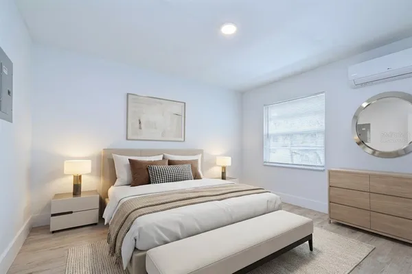 a bedroom with a bed and wooden floor