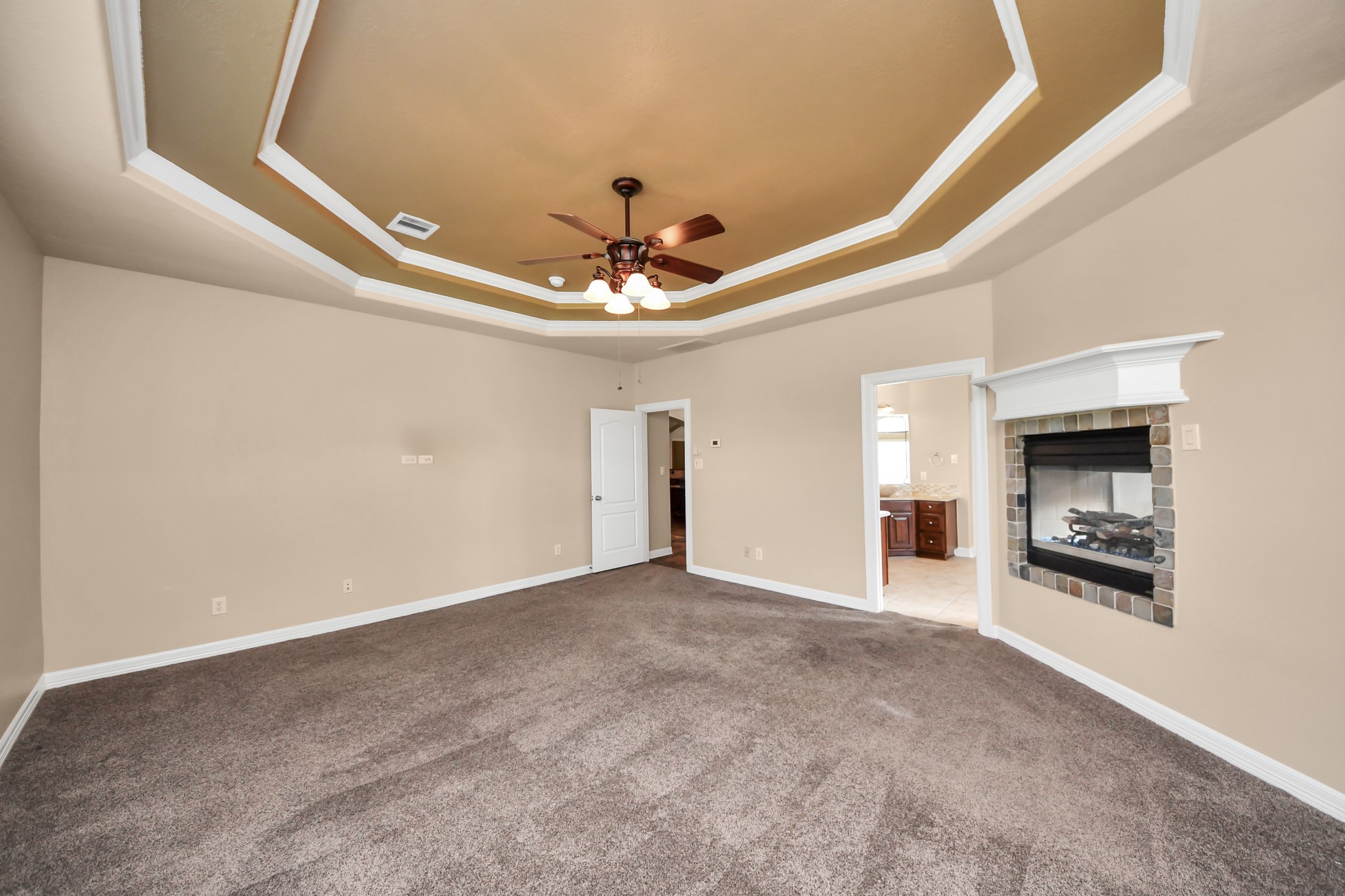 3511 River Bend Drive Rosenberg, TX 77471 - Photo 21 of 50 Elegant master retreat with a warm fireplace and stunning coffered ceiling design