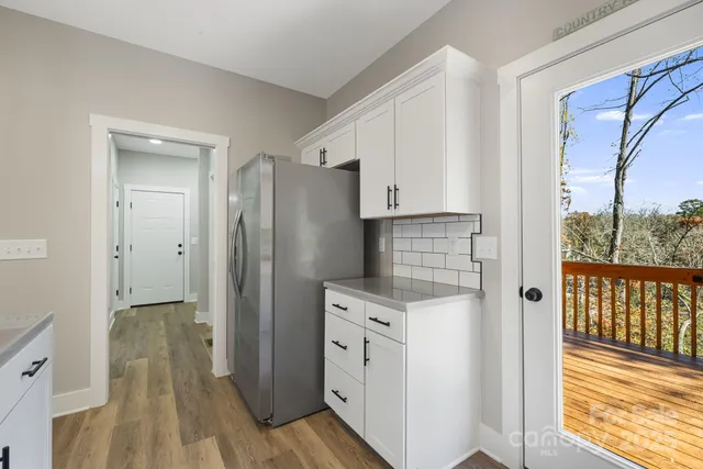 a kitchen with stainless steel appliances a refrigerator and a cabinets