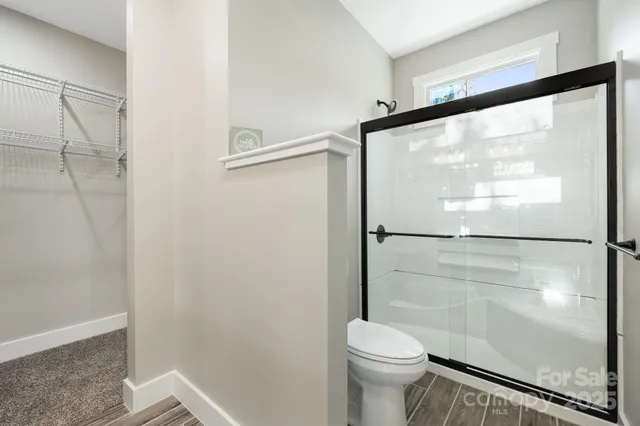 a bathroom with a glass shower door