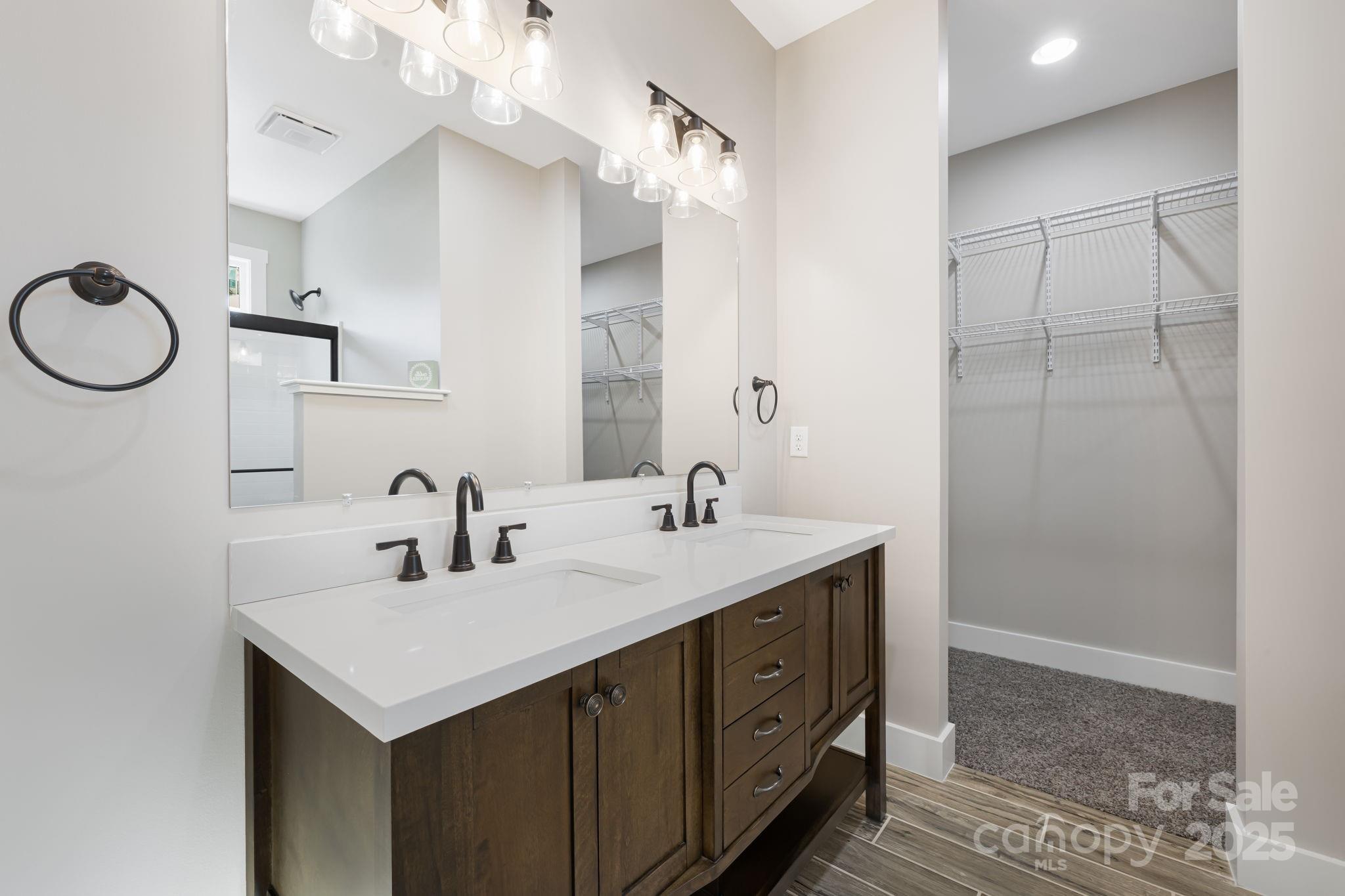 129 Brentwood Road Morganton, NC 28655 - Photo 16 of 28 a bathroom with a sink a light fixture and a mirror