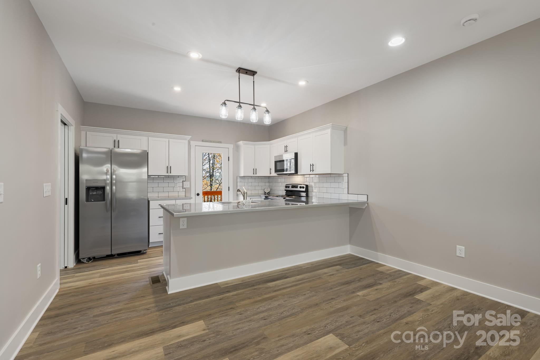 129 Brentwood Road Morganton, NC 28655 - Photo 6 of 28 a view of a kitchen with wooden floor