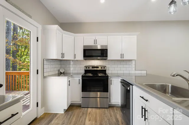 a kitchen with a sink stove and cabinets