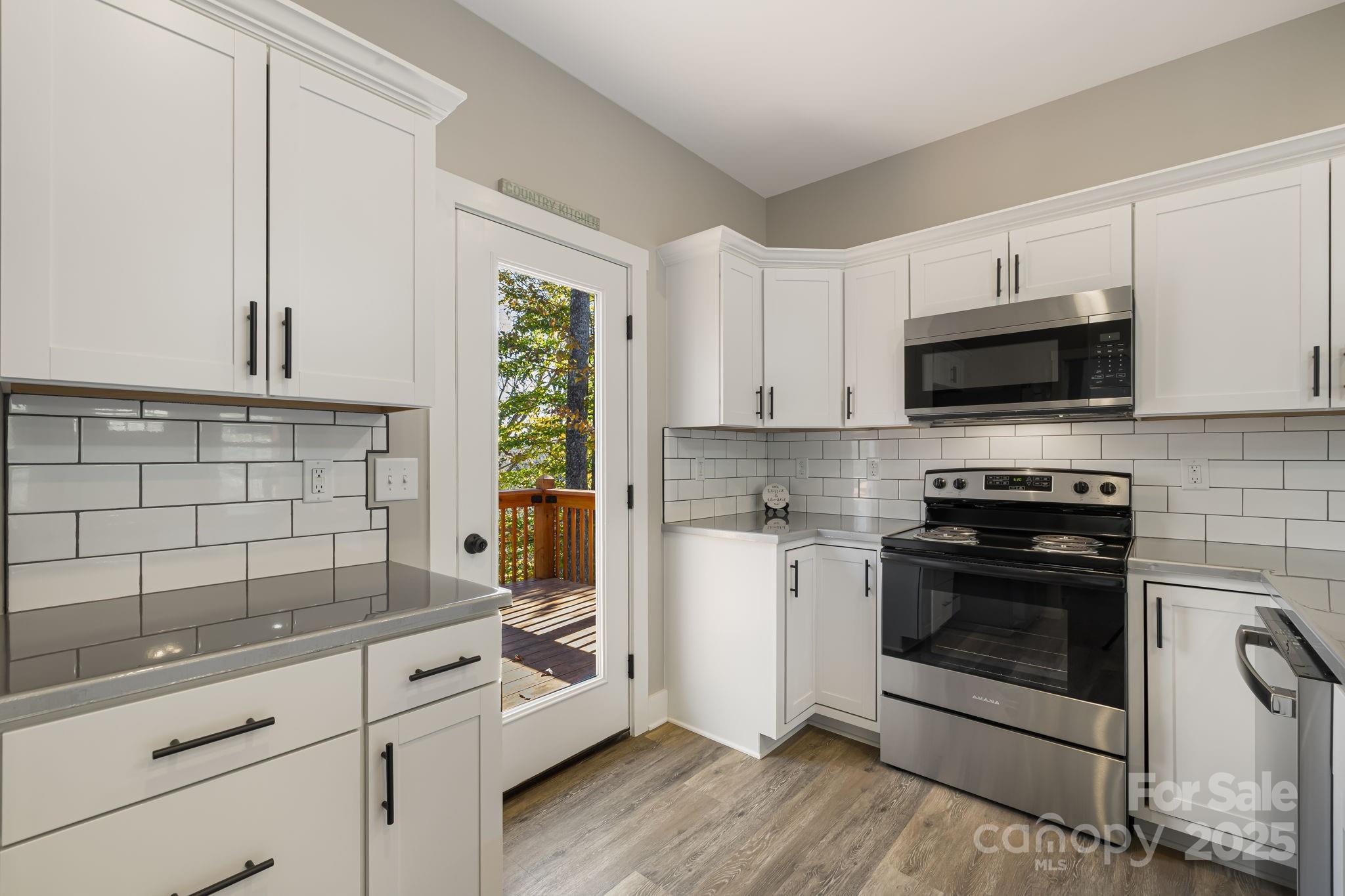 129 Brentwood Road Morganton, NC 28655 - Photo 9 of 28 a kitchen with white cabinets stainless steel appliances and a sink