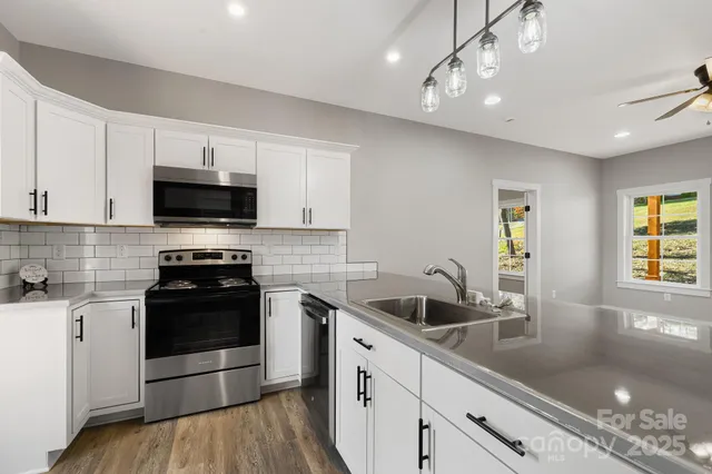 a kitchen with a sink stove and microwave