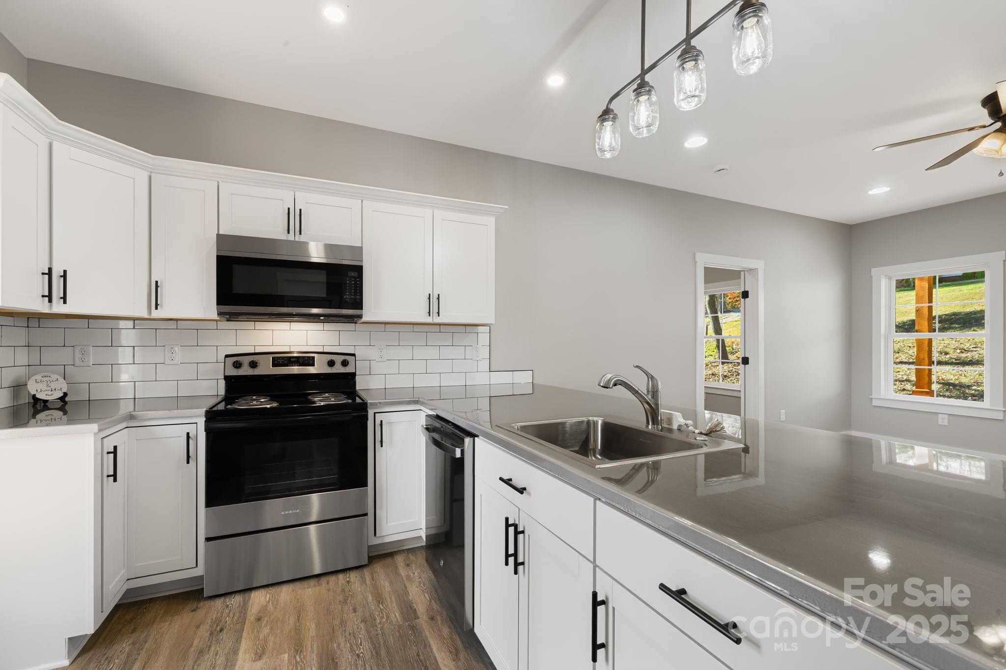 129 Brentwood Road Morganton, NC 28655 - Photo 10 of 28 a kitchen with a sink stove and microwave