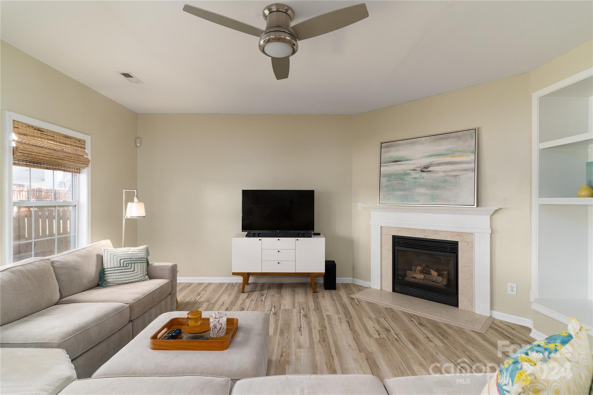 9427 Culcairn Road Huntersville, NC 28078 - Photo 17 of 39 a living room with furniture and a fireplace